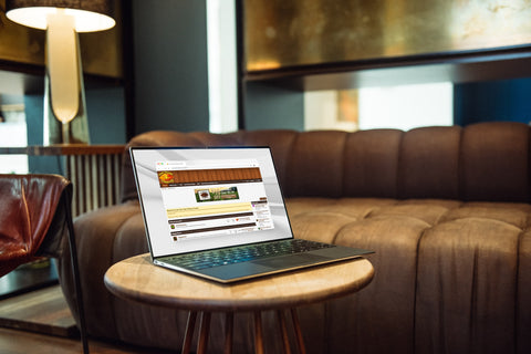 Laptop on a wooden table in a living room setting